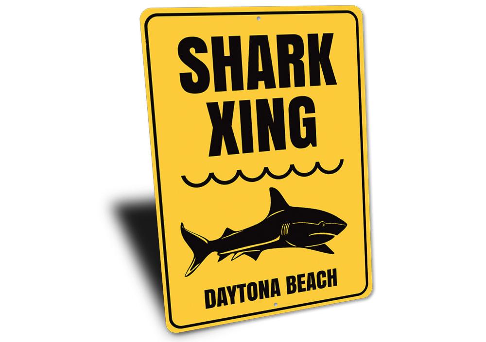 A decorative Beach Name Shark Crossing Sign made of durable aluminum, featuring a vibrant design perfect for coastal decor.