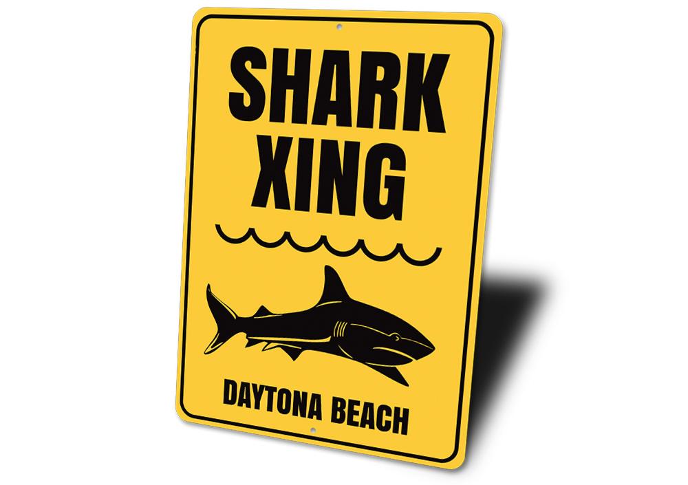 A decorative Beach Name Shark Crossing Sign made of durable aluminum, featuring a vibrant design perfect for coastal decor.