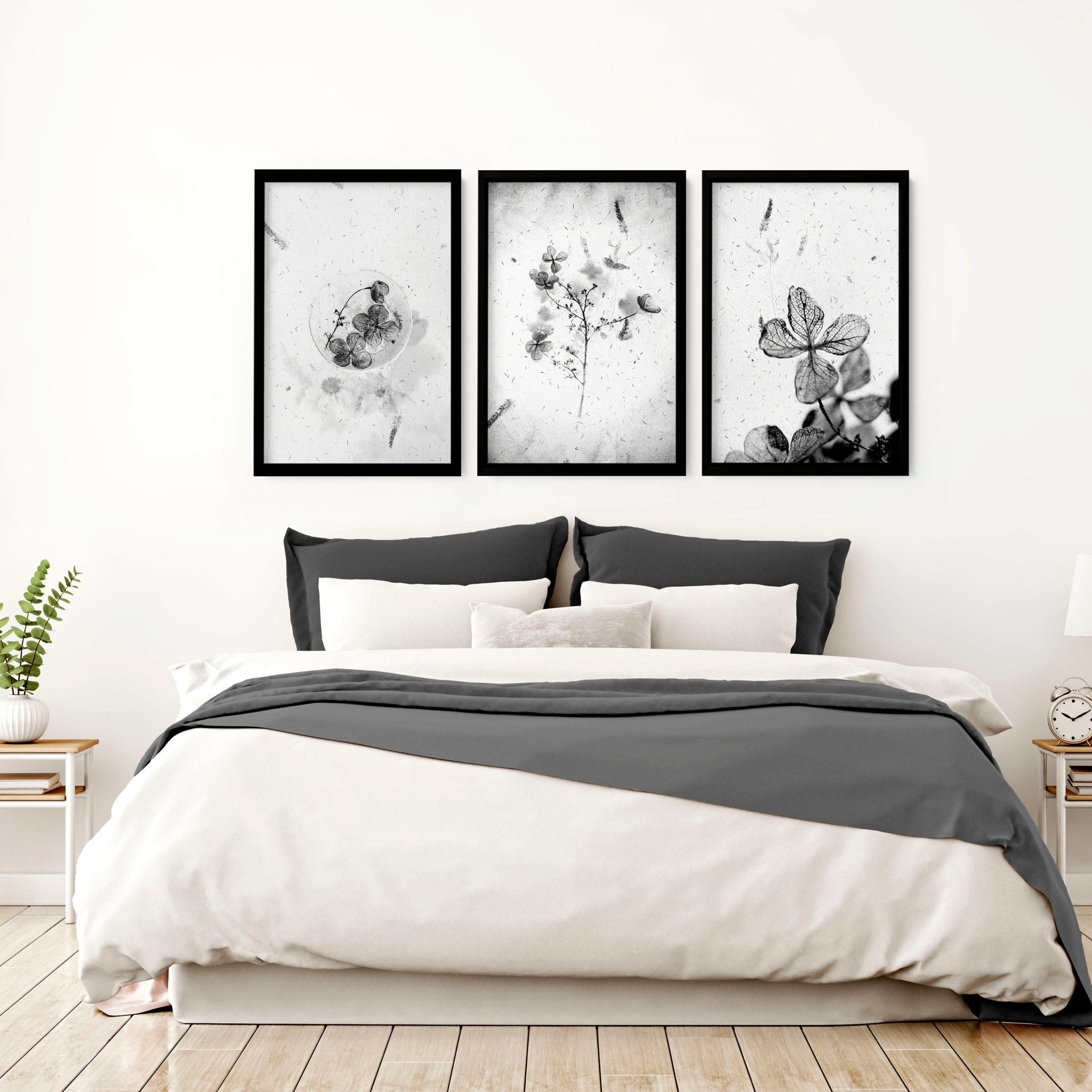 Set of 3 framed wall art prints featuring Greyscale Dry Floral Botanicals, elegantly displayed for bedroom decor.