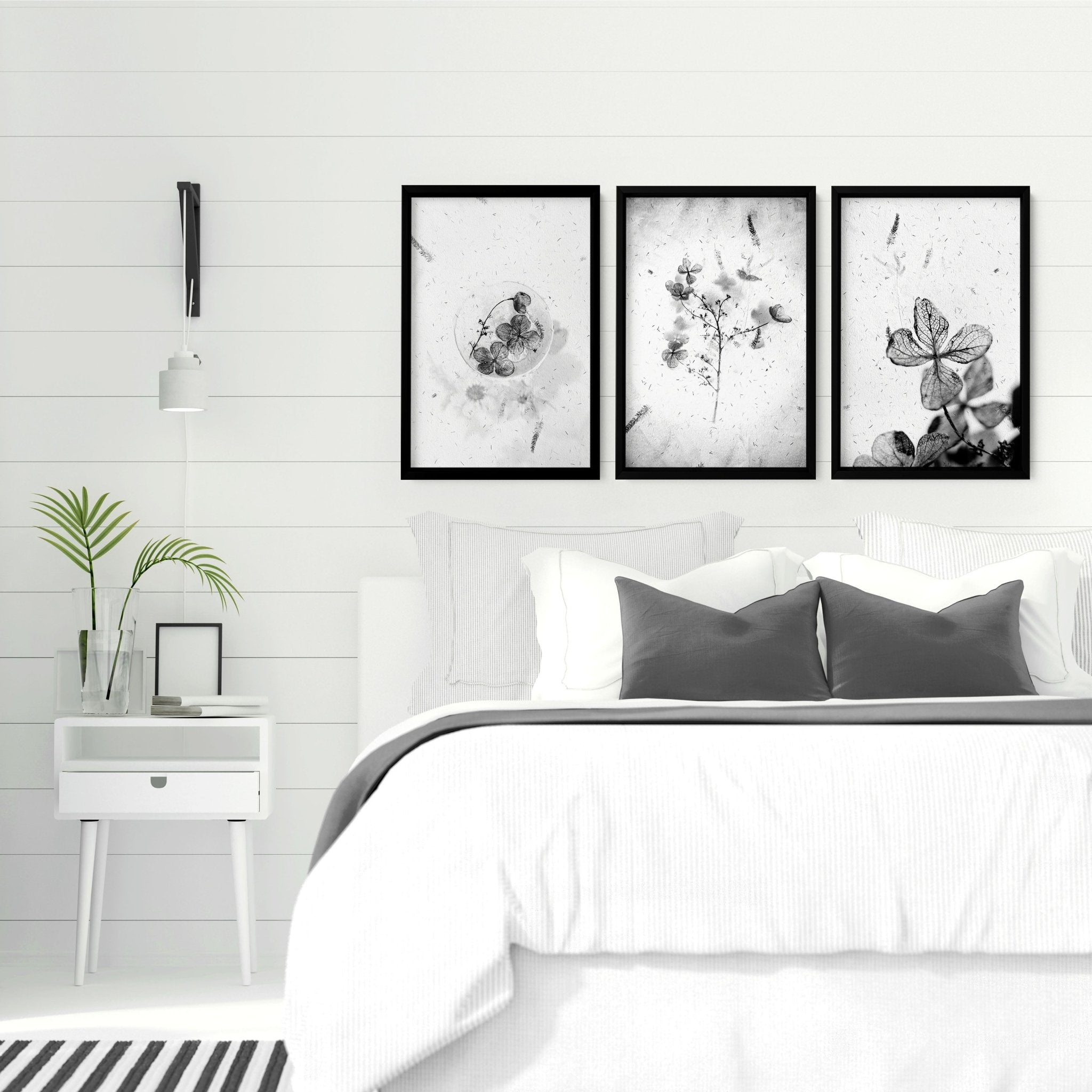 Set of 3 framed wall art prints featuring Greyscale Dry Floral Botanicals, elegantly displayed for bedroom decor.