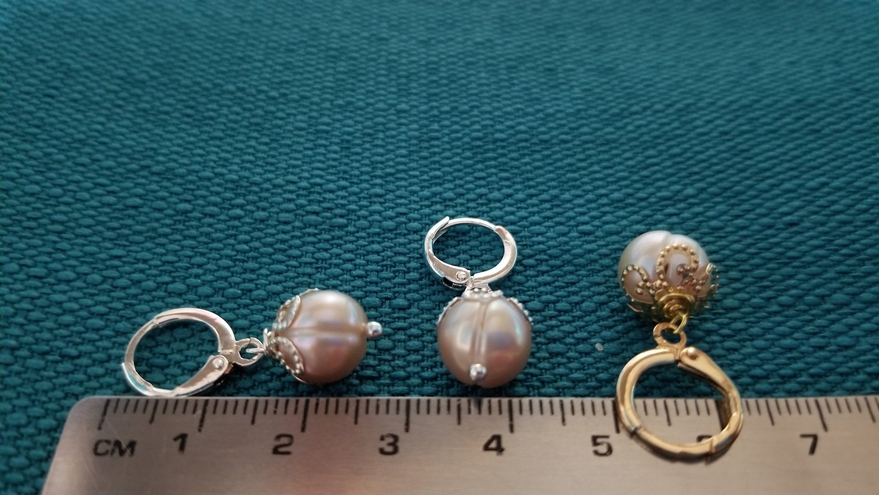 Elegant beige pearl hoop earrings with golden and silver options, showcasing a simple yet stylish design.