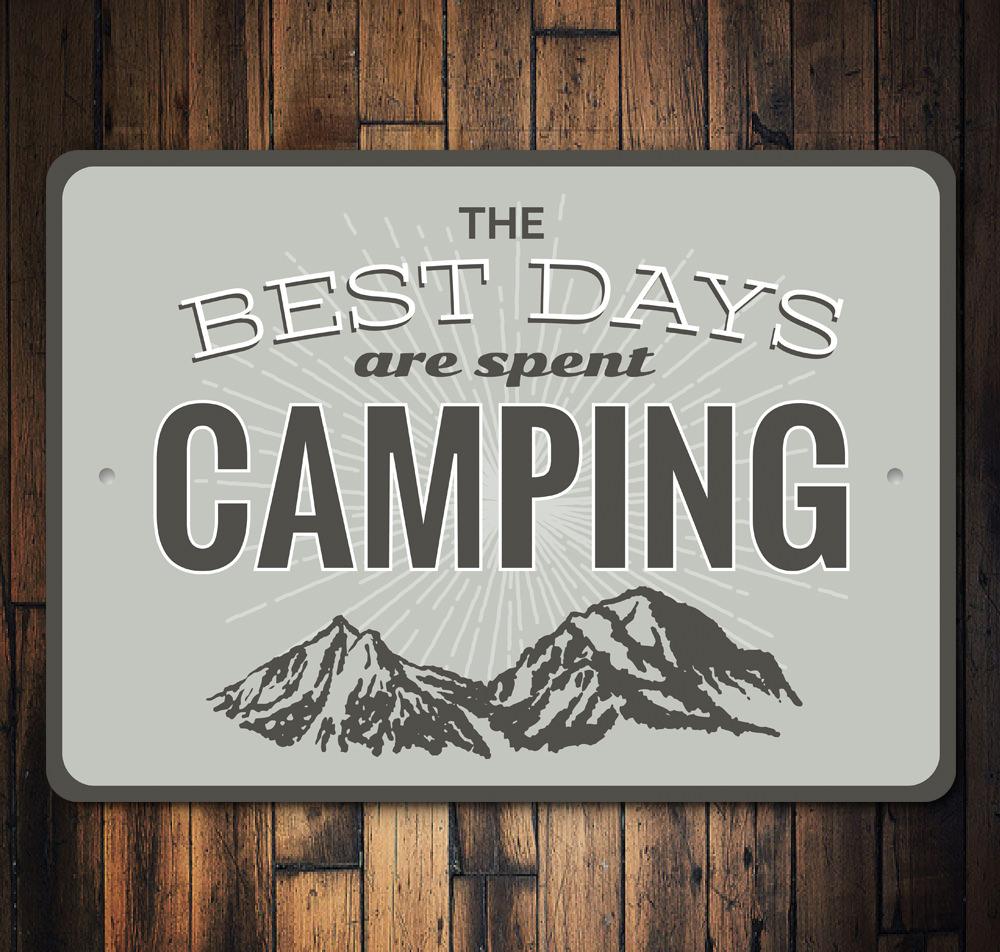 A decorative metal sign that reads 'Best Days are Spent Camping', featuring a rustic design suitable for indoor or outdoor display.