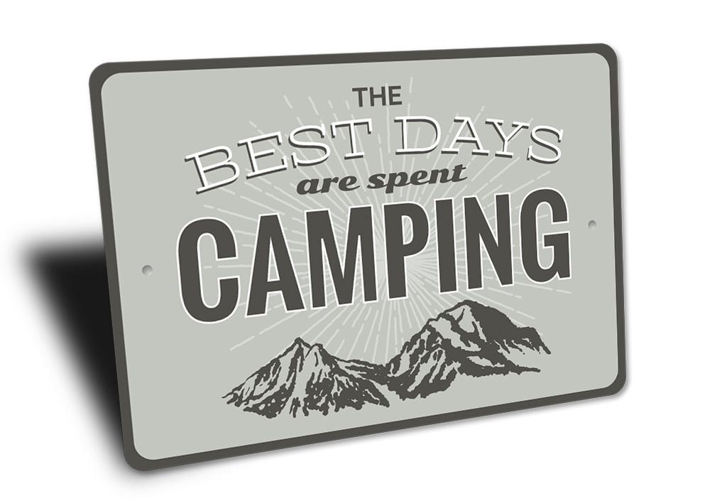 A decorative metal sign that reads 'Best Days are Spent Camping', featuring a rustic design suitable for indoor or outdoor display.