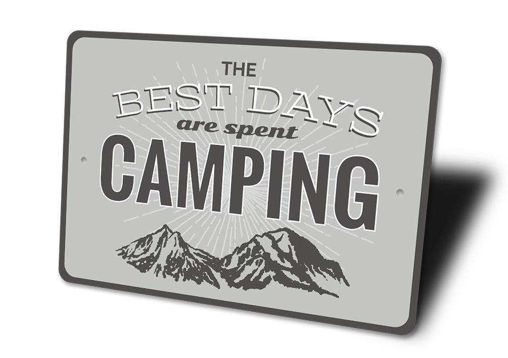 A decorative metal sign that reads 'Best Days are Spent Camping', featuring a rustic design suitable for indoor or outdoor display.