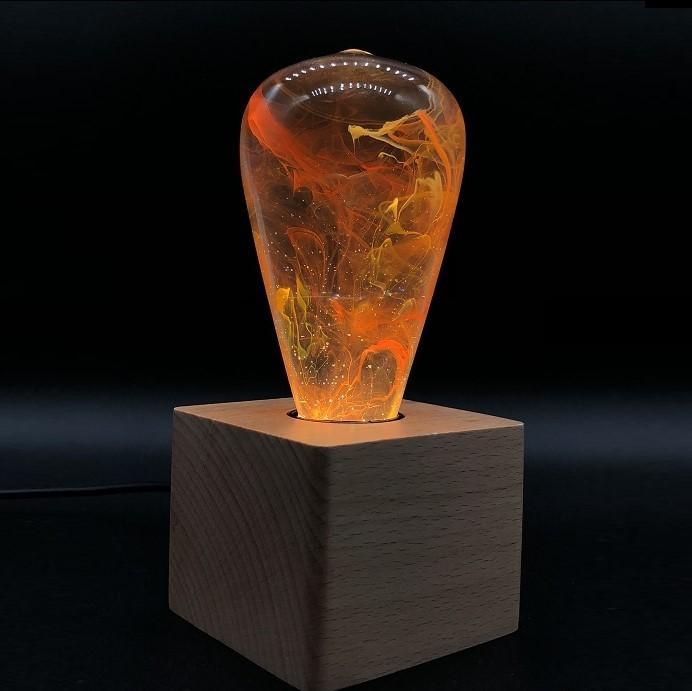 Best Seller Bundle featuring three eco-friendly LED bulbs in mixed colors, handcrafted with resin and beech wood.