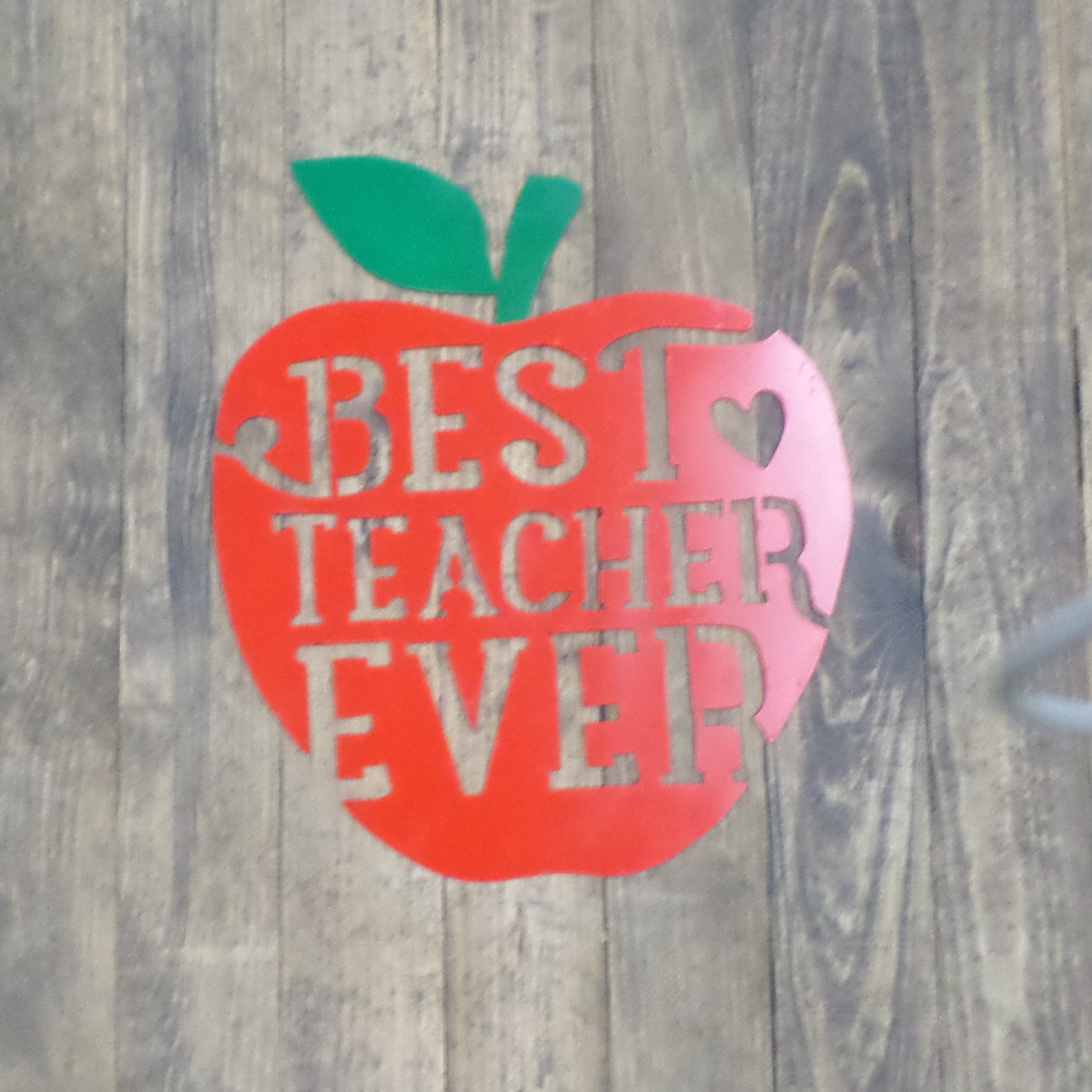 Best Teacher Ever Apple metal wall art, featuring a vibrant apple design made from high-quality steel, perfect for classroom decor.