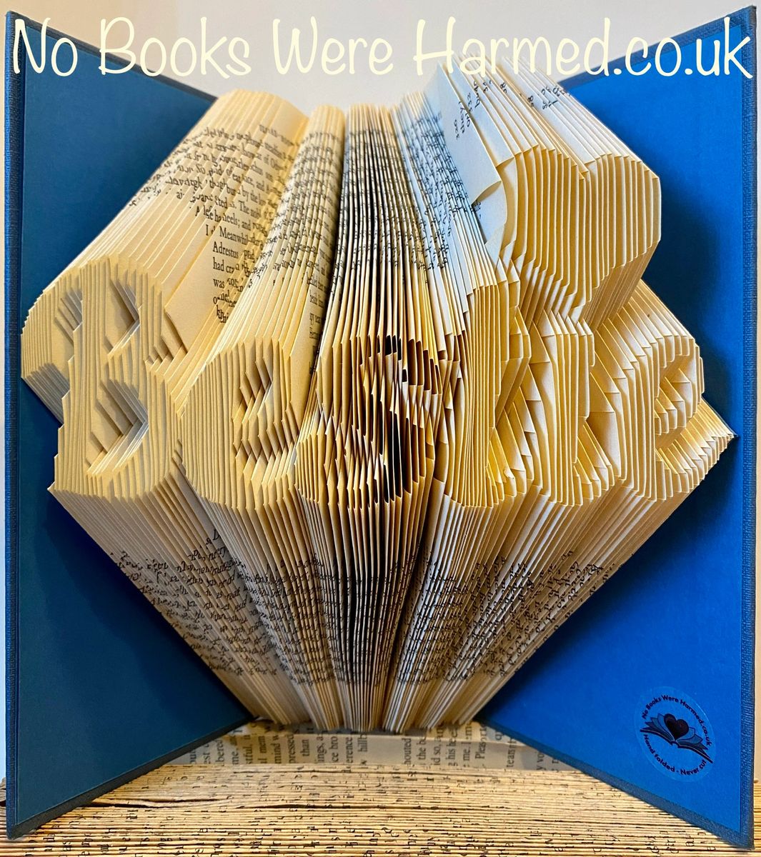 Hand-folded book art titled 'Bestie' featuring a love heart design, crafted from vintage books.