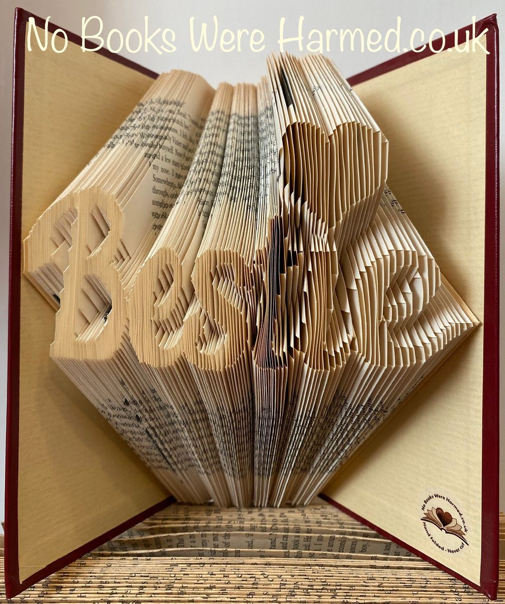 Hand-folded book art titled 'Bestie' featuring a love heart design, crafted from vintage books.