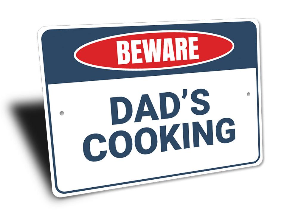 Beware Dad's Cooking Sign made of high-quality aluminum, featuring a humorous design perfect for kitchen decor.