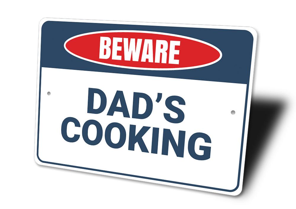 Beware Dad's Cooking Sign made of high-quality aluminum, featuring a humorous design perfect for kitchen decor.