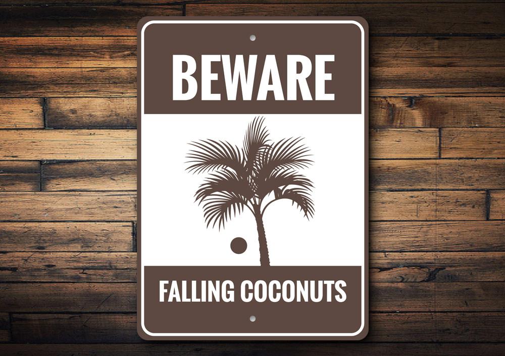 Beware Falling Coconuts Sign made of high-quality aluminum, featuring a playful design perfect for beach houses and coastal decor.