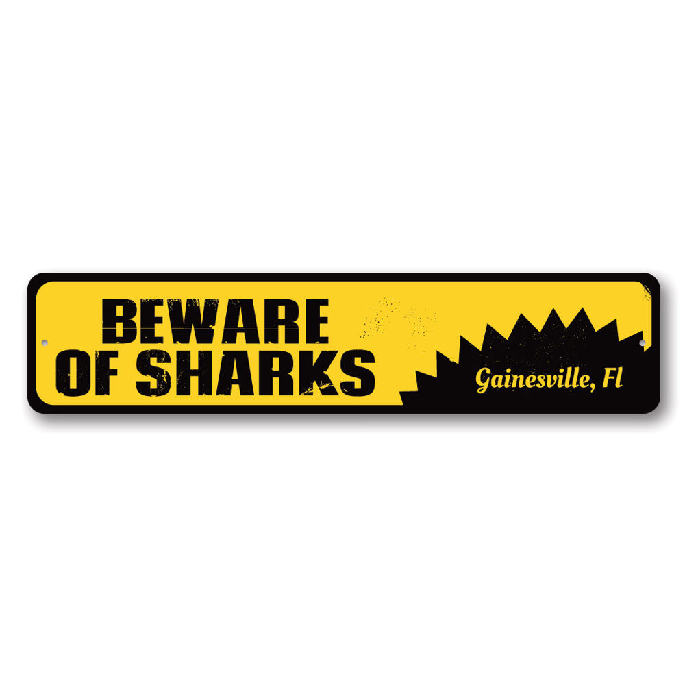 A decorative 'Beware of Sharks' sign made of aluminum, featuring vibrant colors and a playful design, perfect for beach houses and seafood restaurants.