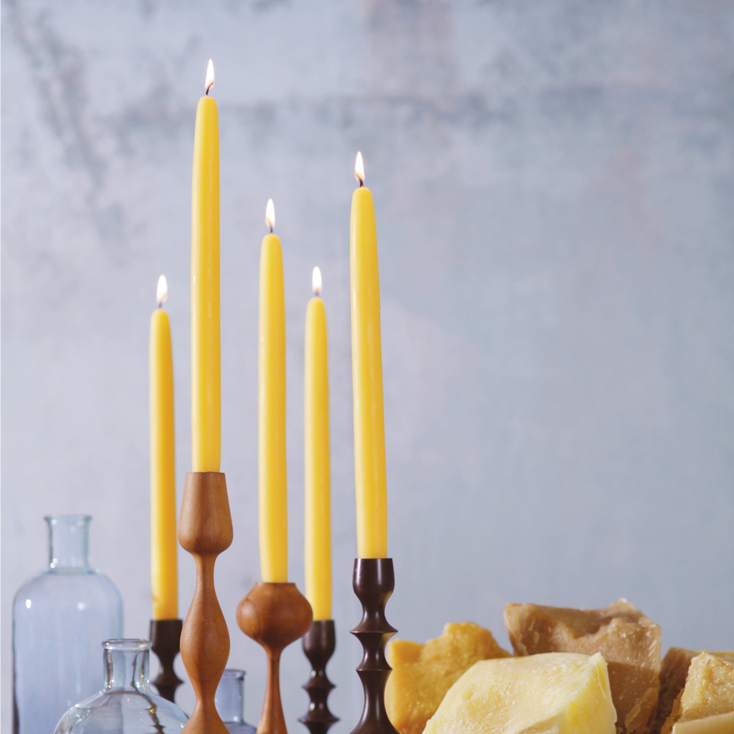 A pair of elegant Big Dipper Wax Works 100% Pure Beeswax STANDARD Tapers, hand-dipped and showcasing a warm golden hue.