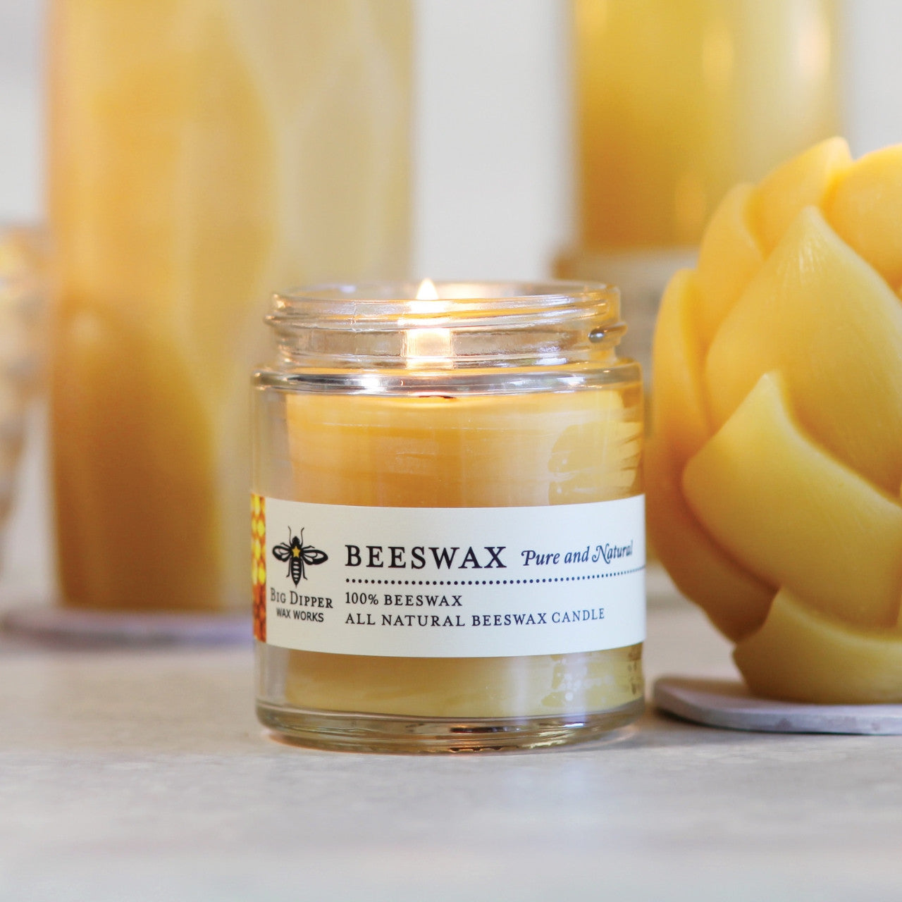 Big Dipper Wax Works Pure Beeswax Apothecary Glass candle in a clear reusable glass jar, showcasing its natural beeswax color.