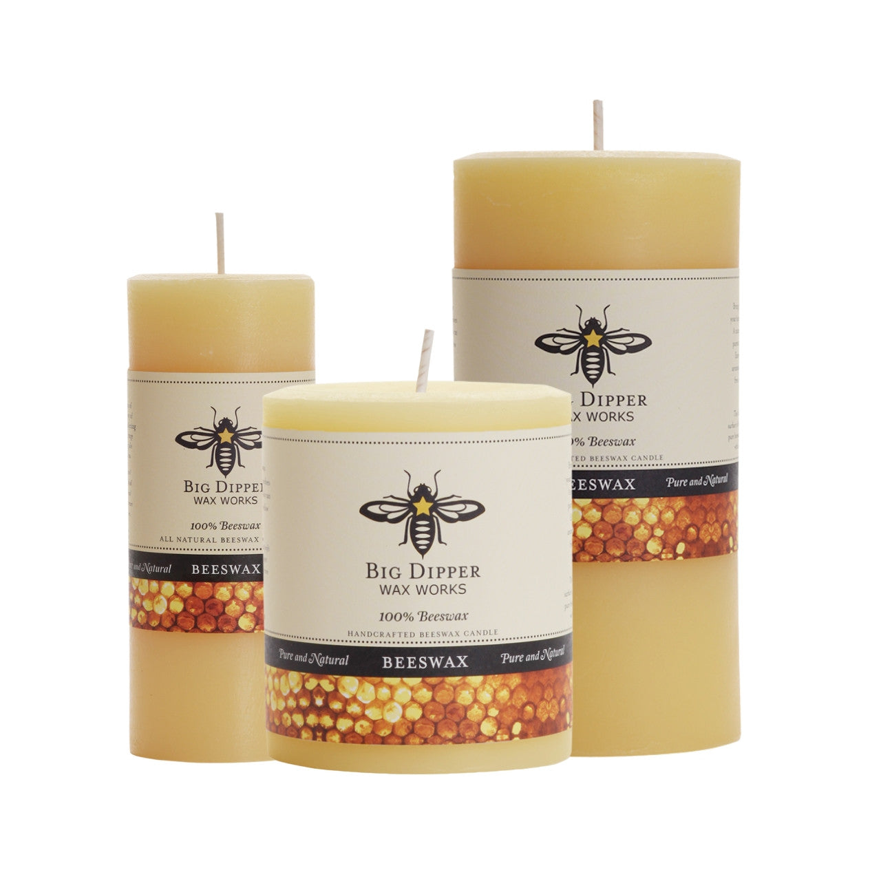 Big Dipper Wax Works Pure Beeswax Pillars in various sizes and colors, showcasing their elegant design and natural honey fragrance.