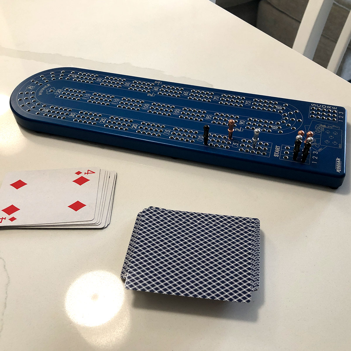 A premium Billet Aluminum Cribbage Board with anodized finishes in various colors, featuring large numbers and custom pegs.