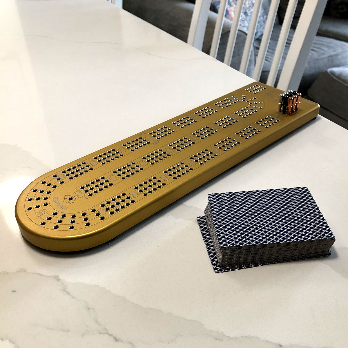 A premium Billet Aluminum Cribbage Board with anodized finishes in various colors, featuring large numbers and custom pegs.