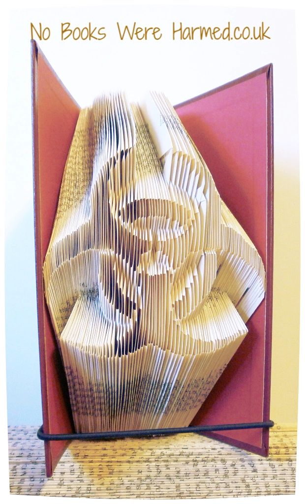 Hand-folded Bio Hazard symbol art made from vintage book pages, showcasing intricate design and unique colors.