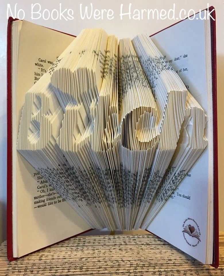 Hand-folded book art titled 'Bitch', crafted from vintage books, showcasing intricate designs and unique character.