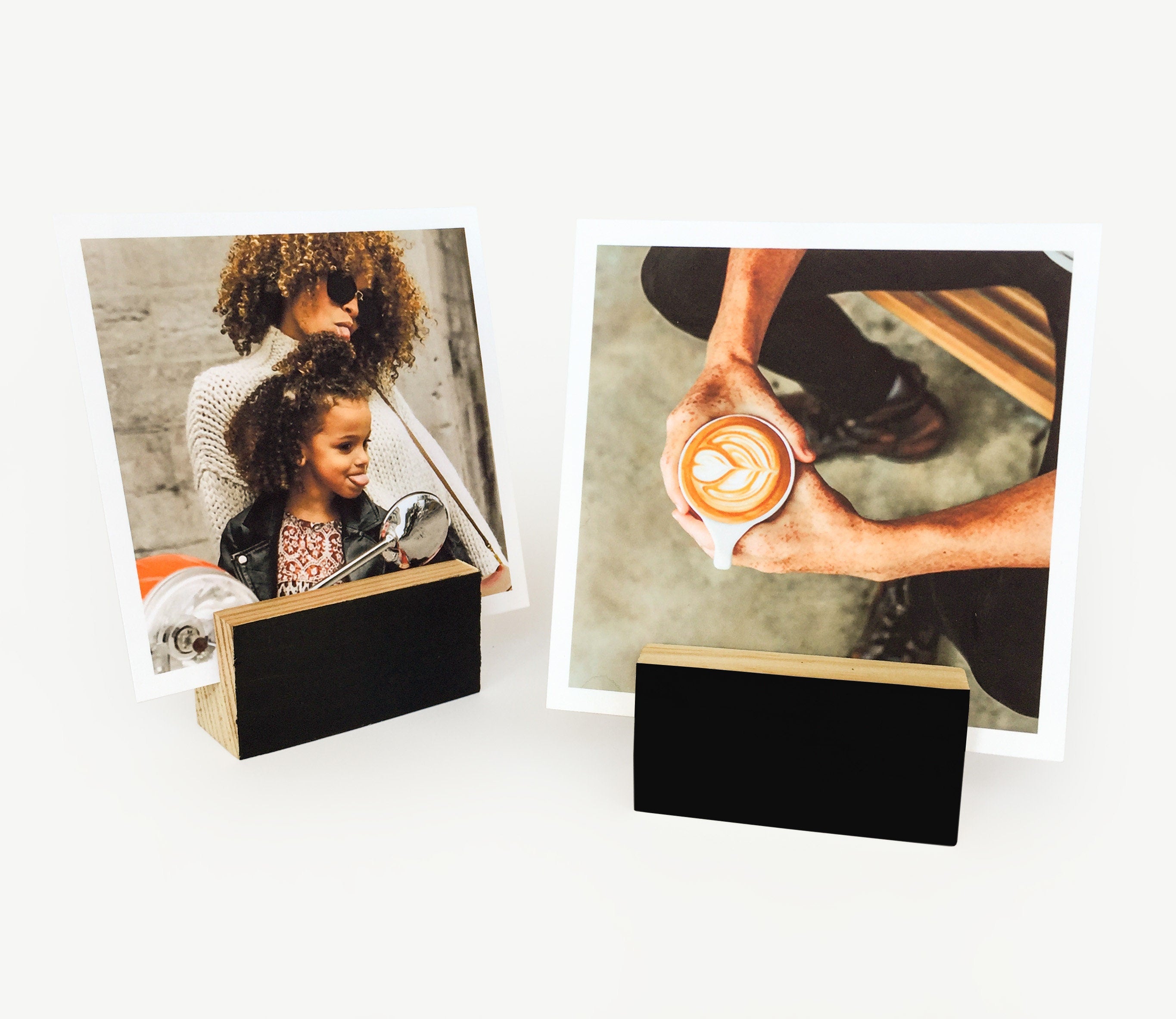 A stylish black wood block card holder displaying various art prints and photos, perfect for desks and shelves.