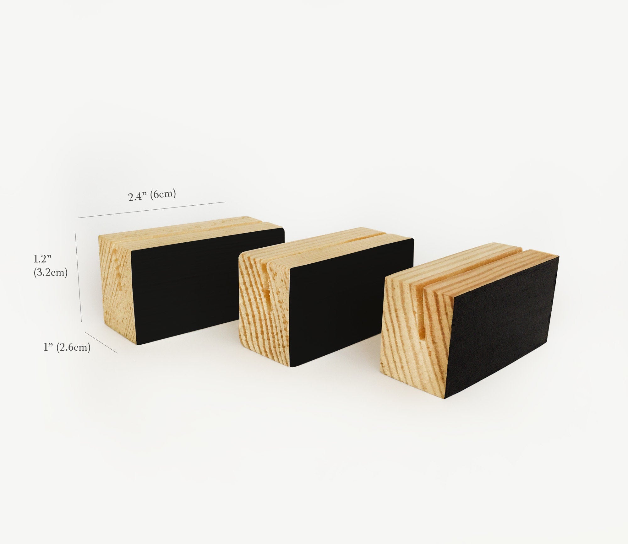 A stylish black wood block card holder displaying various art prints and photos, perfect for desks and shelves.