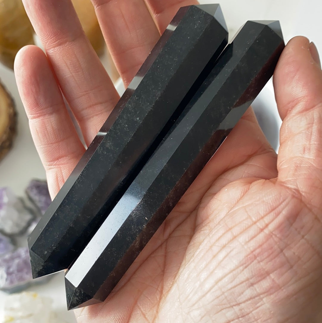 A 4.5-inch Black Chalcedony Faceted Wand, showcasing its smooth surface and deep black color, perfect for energy work and meditation.