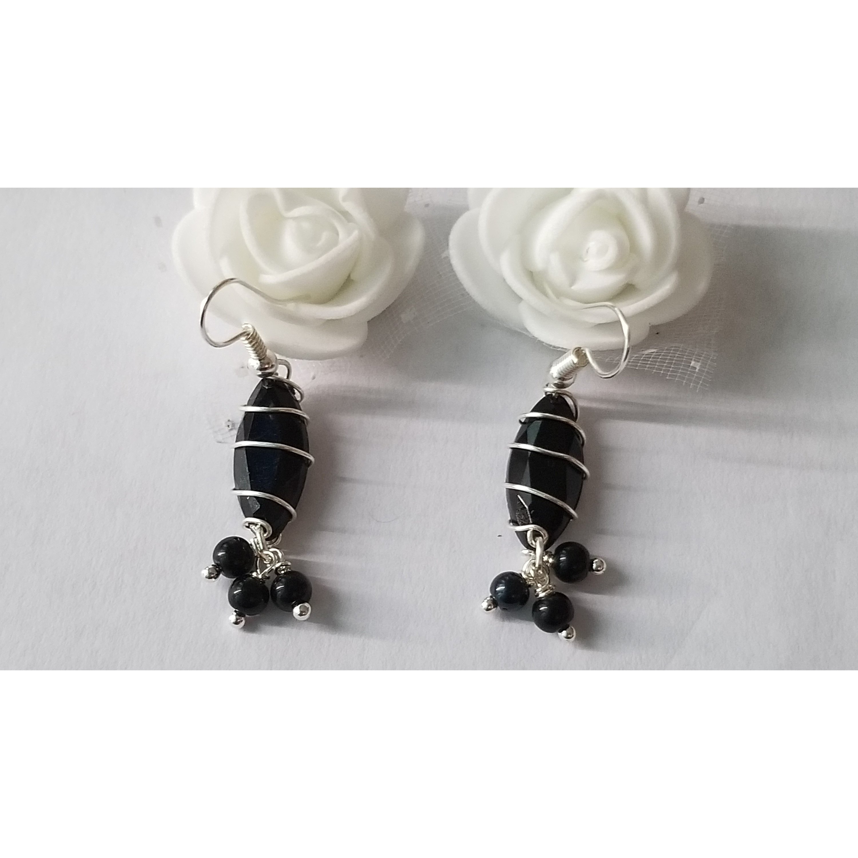 Elegant handmade black drop earrings with dangle design, showcasing unique craftsmanship.