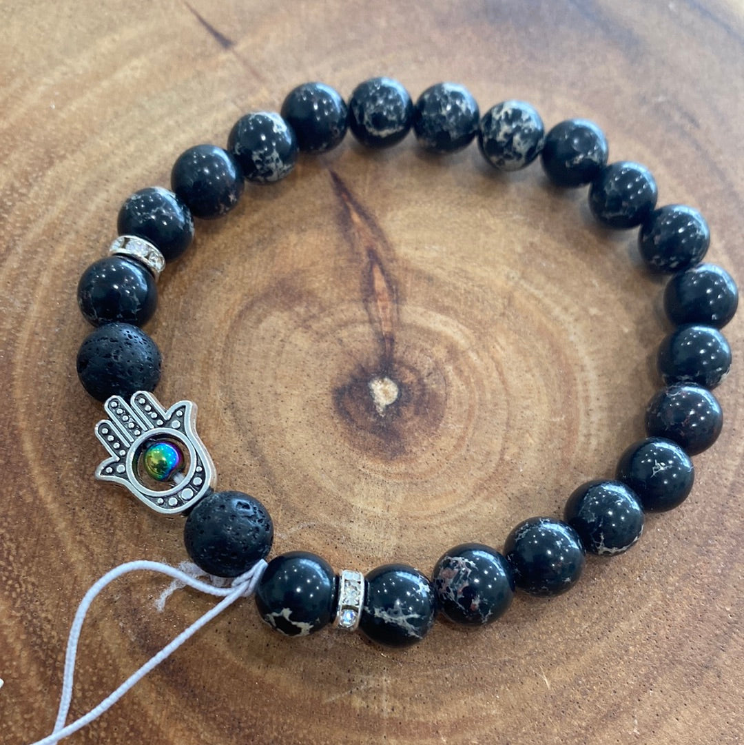 Black Imperial Jasper Hasma Bracelet featuring black jasper beads, symbolizing strength and vitality, elegantly crafted for spiritual enhancement.