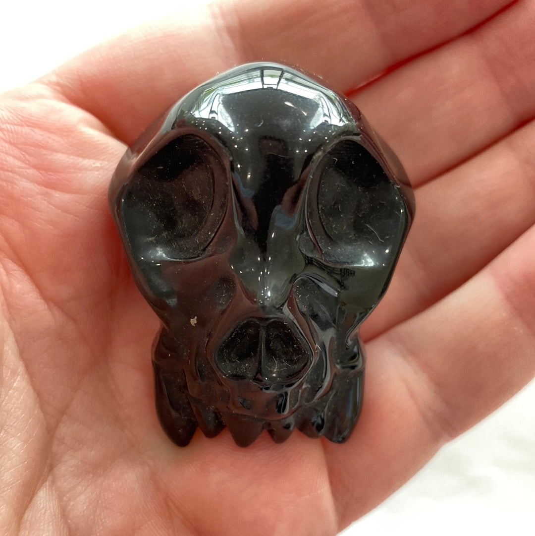 A beautifully crafted Black Obsidian Carving with a glossy finish, showcasing intricate designs and natural volcanic glass texture.