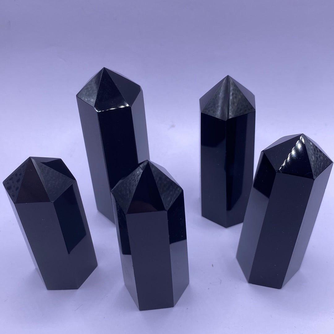 A beautiful Black Obsidian Faceted Point, showcasing its glossy surface and unique shape, perfect for healing and decoration.