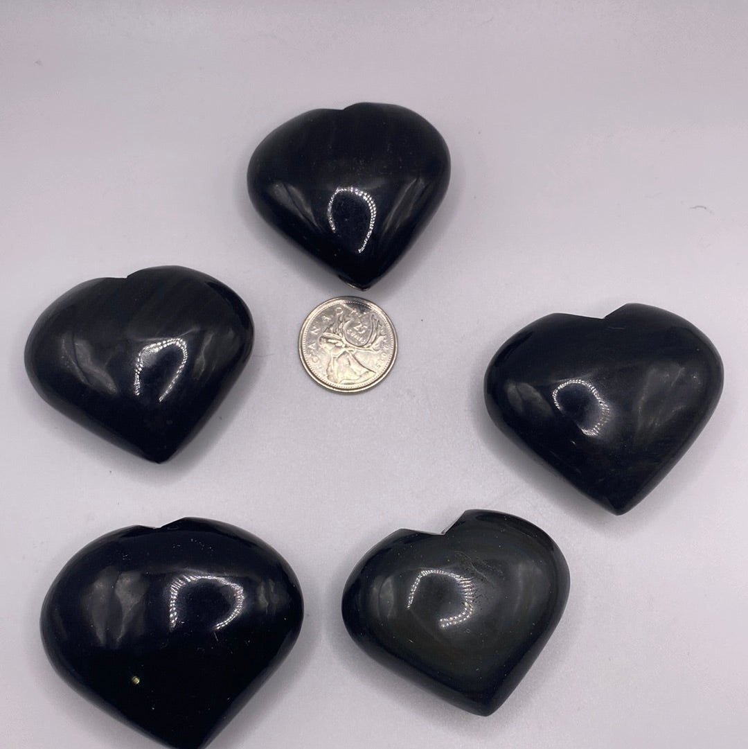 A polished Black Obsidian Heart, 2 inches wide, showcasing its glossy surface and natural volcanic glass texture.