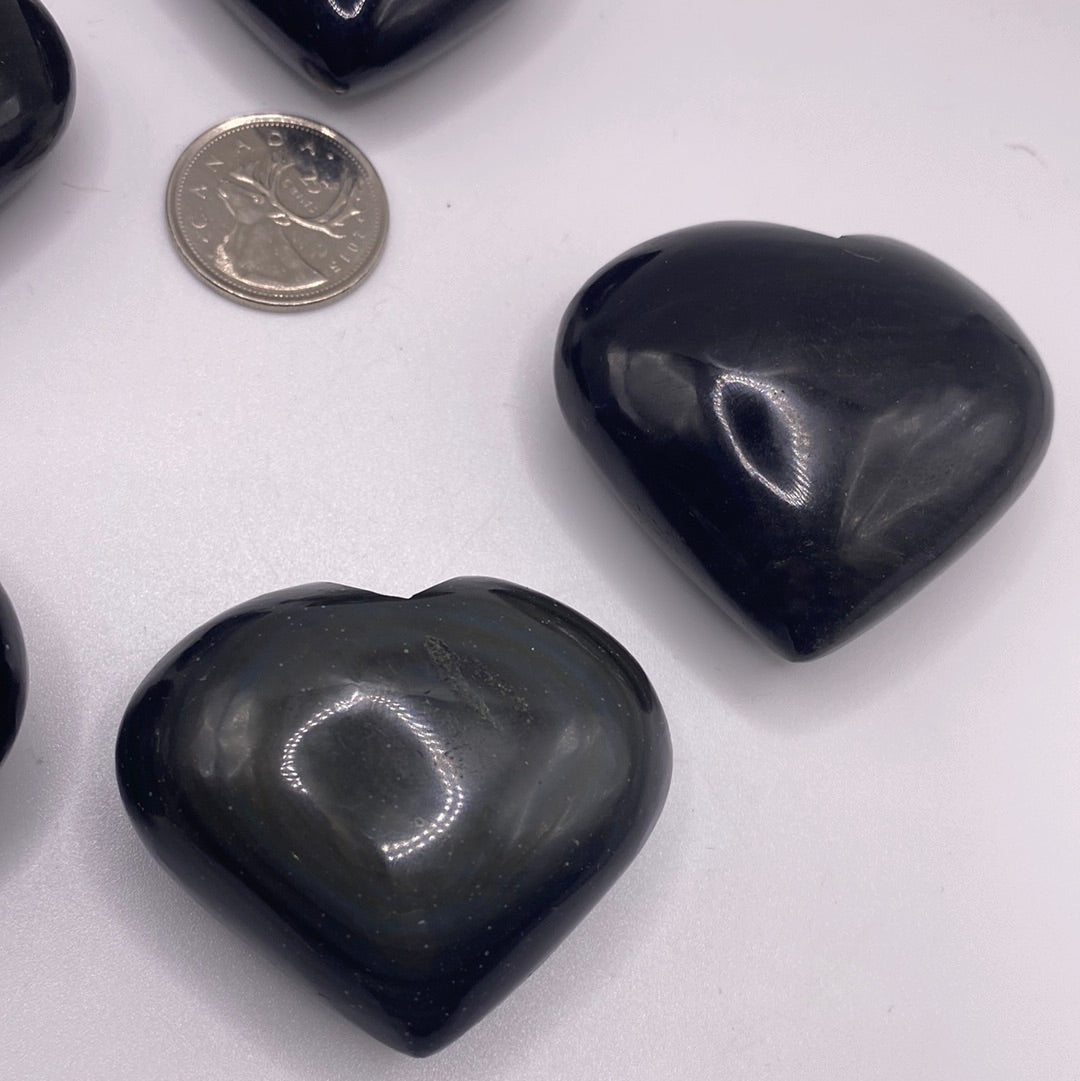 A polished Black Obsidian Heart, 2 inches wide, showcasing its glossy surface and natural volcanic glass texture.