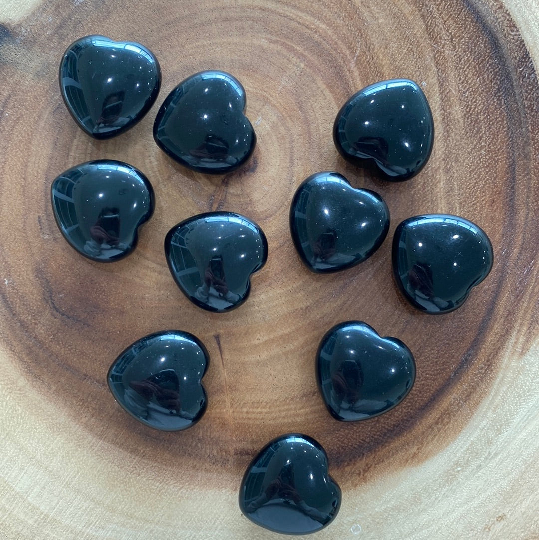 A polished Black Obsidian Heart crystal with a glossy finish, symbolizing protection and emotional healing.