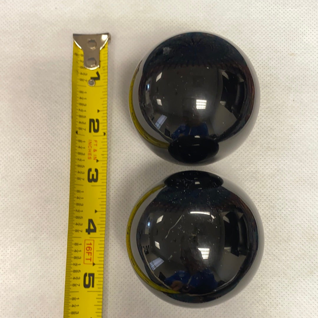 A polished Black Obsidian Sphere, approximately 2.5-3 inches in diameter, showcasing its unique glossy surface and deep black color.