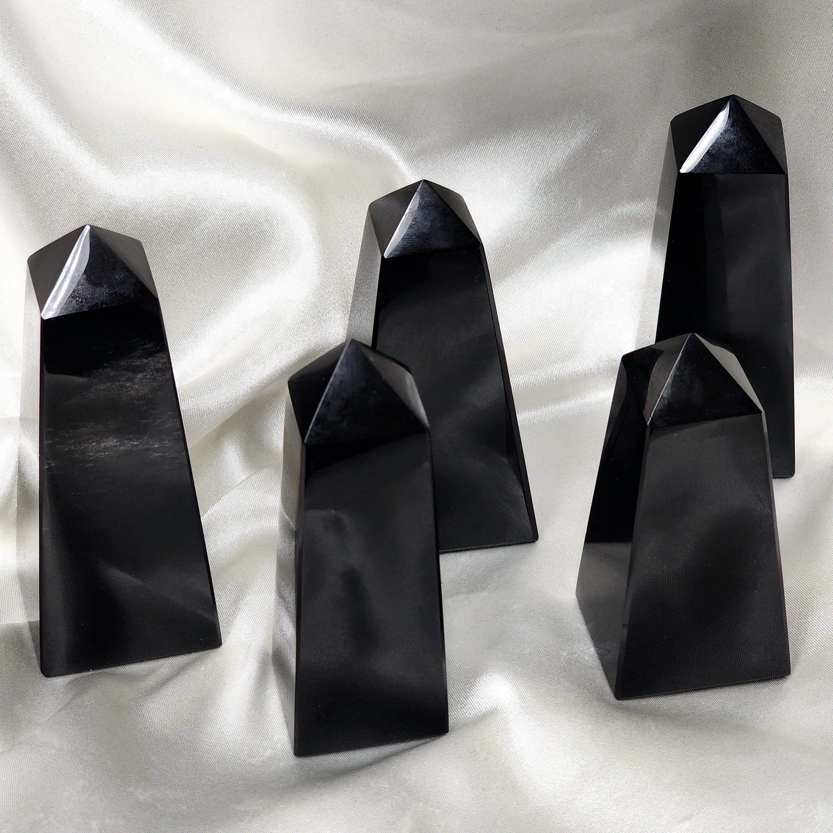 A pair of elegant Black Obsidian Towers showcasing their glossy black surface and sharp edges, perfect for spiritual cleansing and protection.