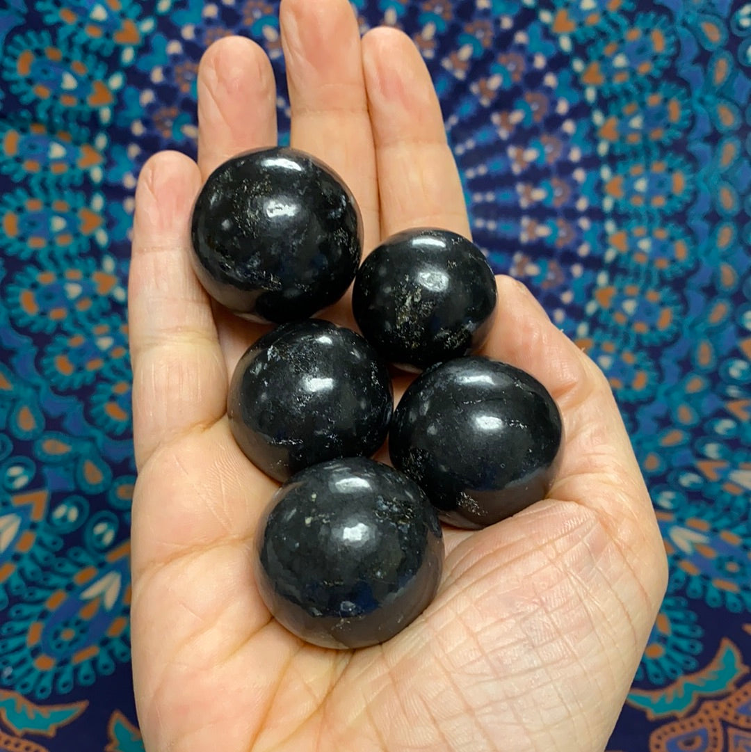 A polished Black Onyx Sphere showcasing its deep black color and smooth surface, symbolizing protection and emotional strength.