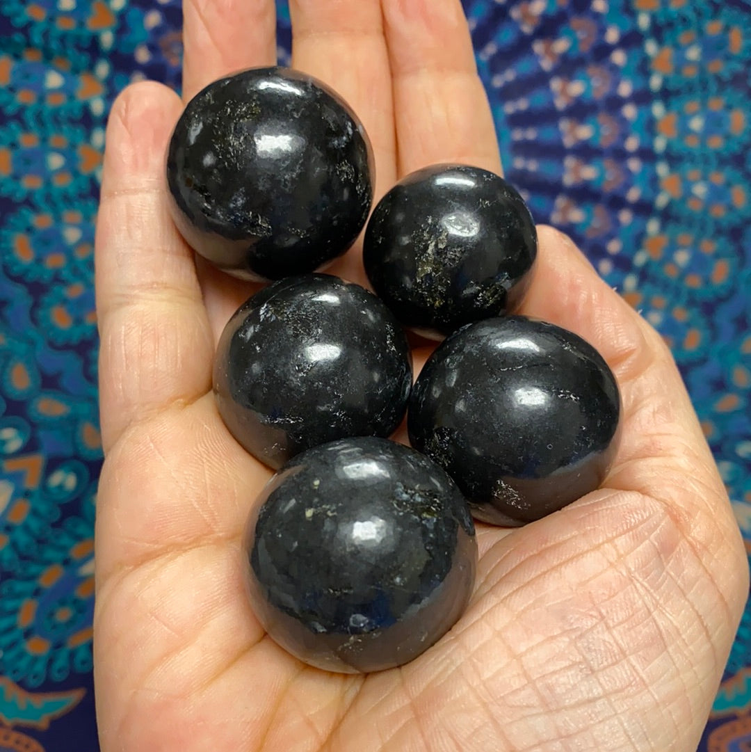 A polished Black Onyx Sphere showcasing its deep black color and smooth surface, symbolizing protection and emotional strength.