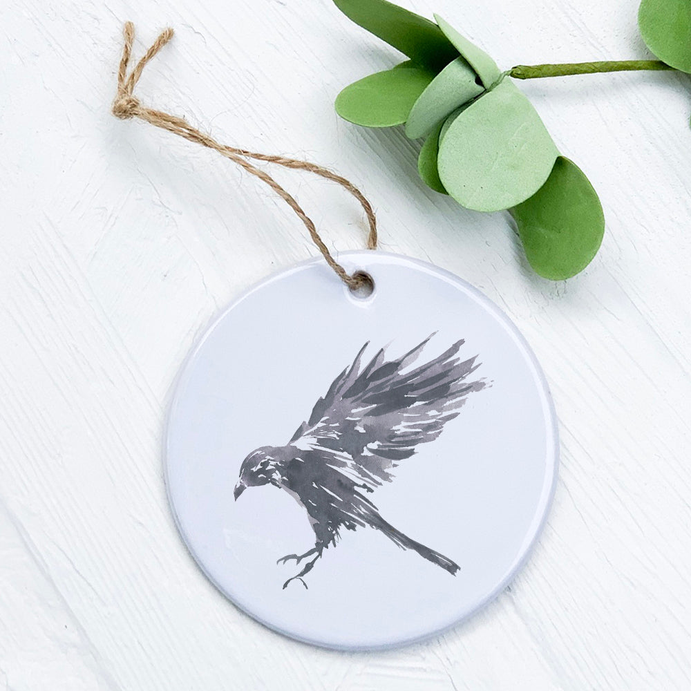 Black Raven Ornament made of high-quality porcelain with a vibrant design, measuring 2.75 inches in diameter.