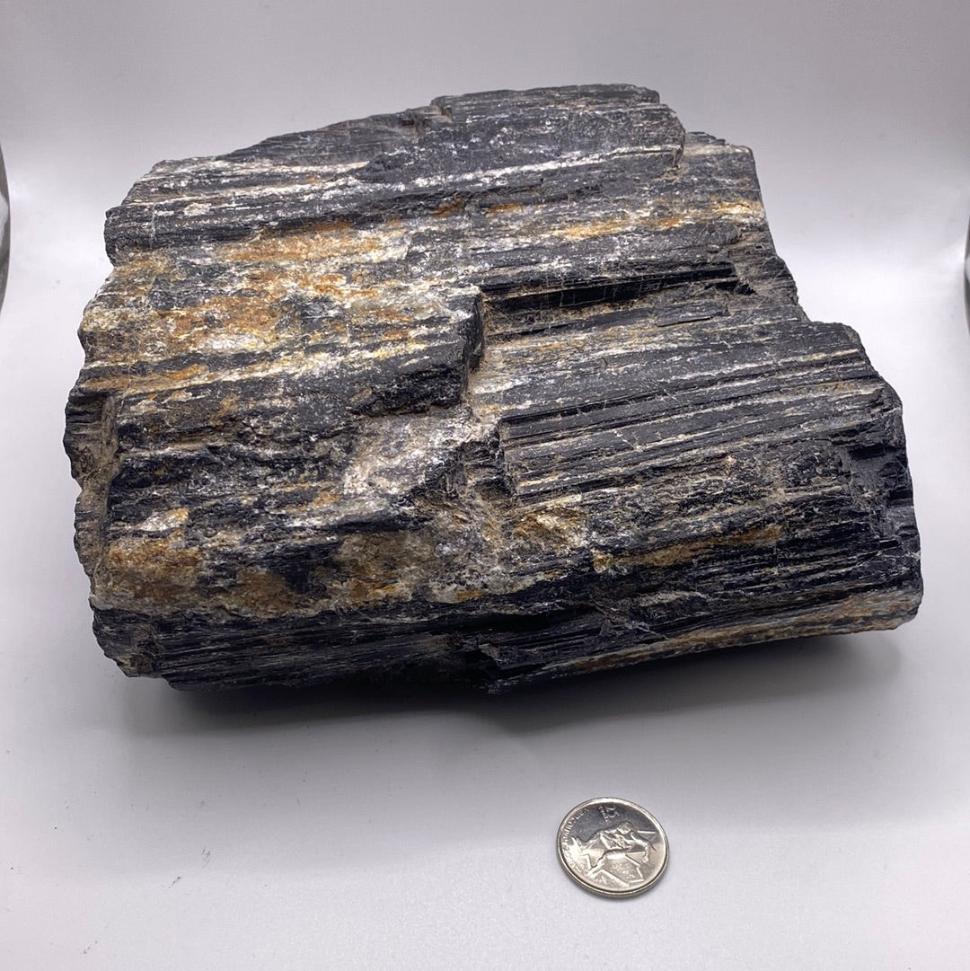 A large 9.7 LB Black Tourmaline specimen with a shiny black and metallic luster, showcasing its unique natural formations.