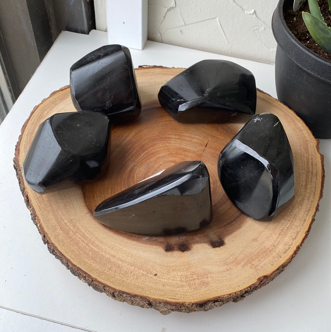 A large, striking Black Tourmaline Freeform crystal showcasing its deep black color and unique shape, perfect for energy protection.