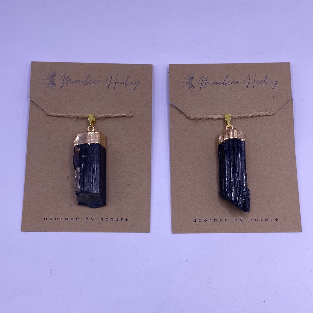 A beautifully handcrafted Black Tourmaline Pendant, showcasing its deep black color and natural crystal texture, symbolizing protection and positive energy.