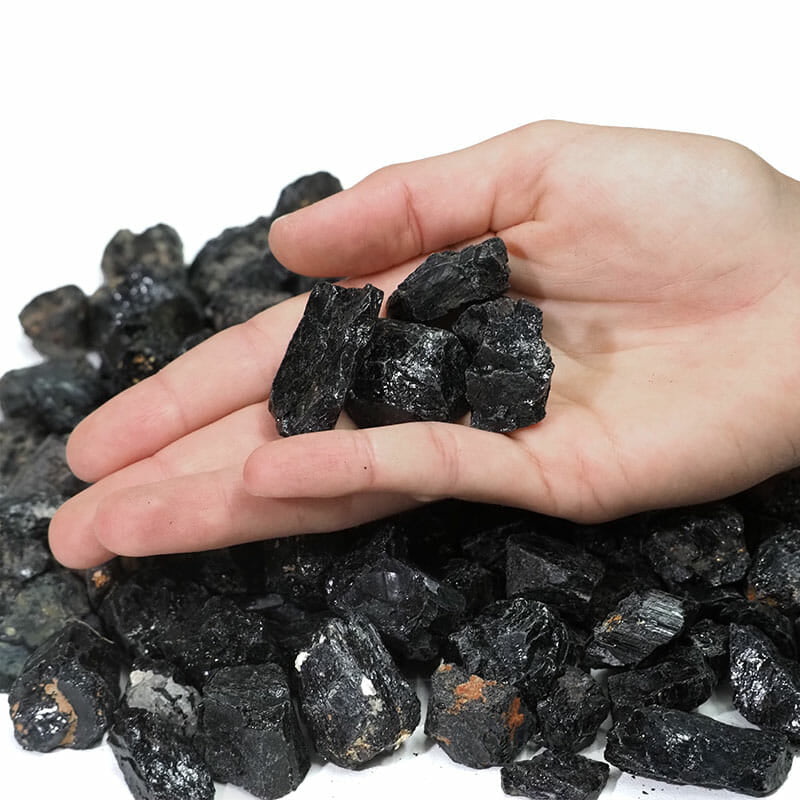 Raw chunks of Black Tourmaline showcasing their natural texture and deep black color, perfect for protection and grounding.