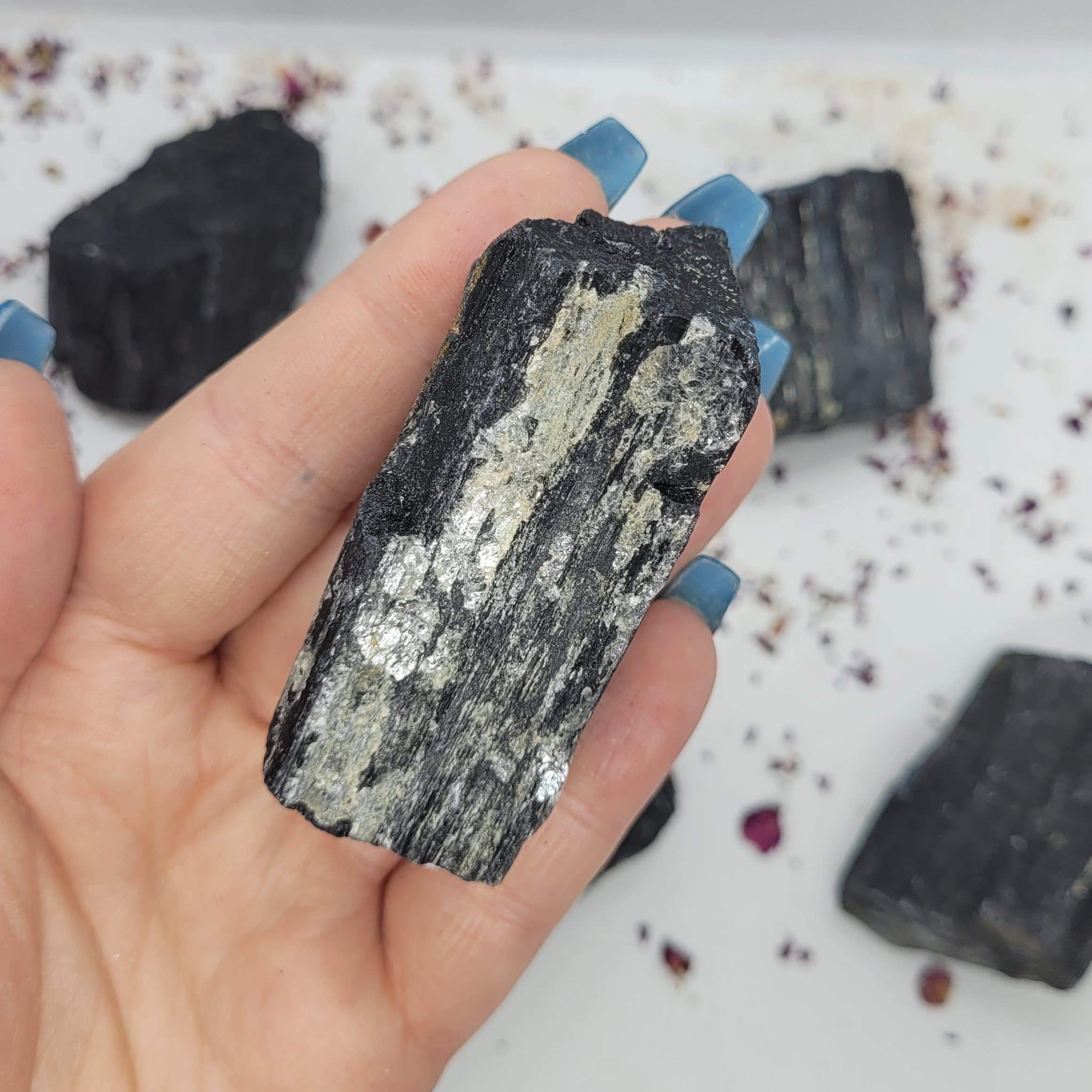 Raw chunks of Black Tourmaline showcasing their unique textures and deep black color, ideal for protection and grounding.