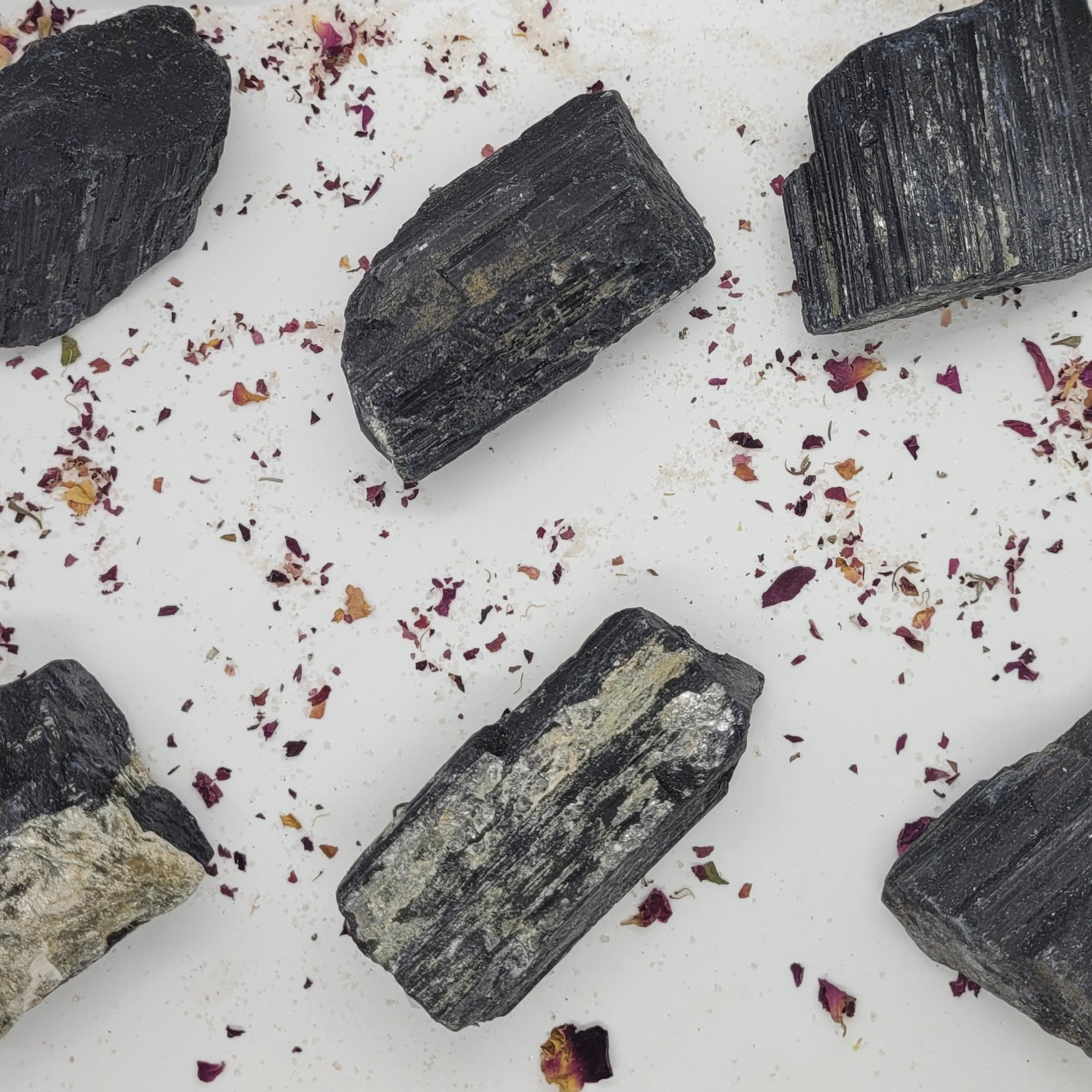 Raw chunks of Black Tourmaline showcasing their unique textures and deep black color, ideal for protection and grounding.