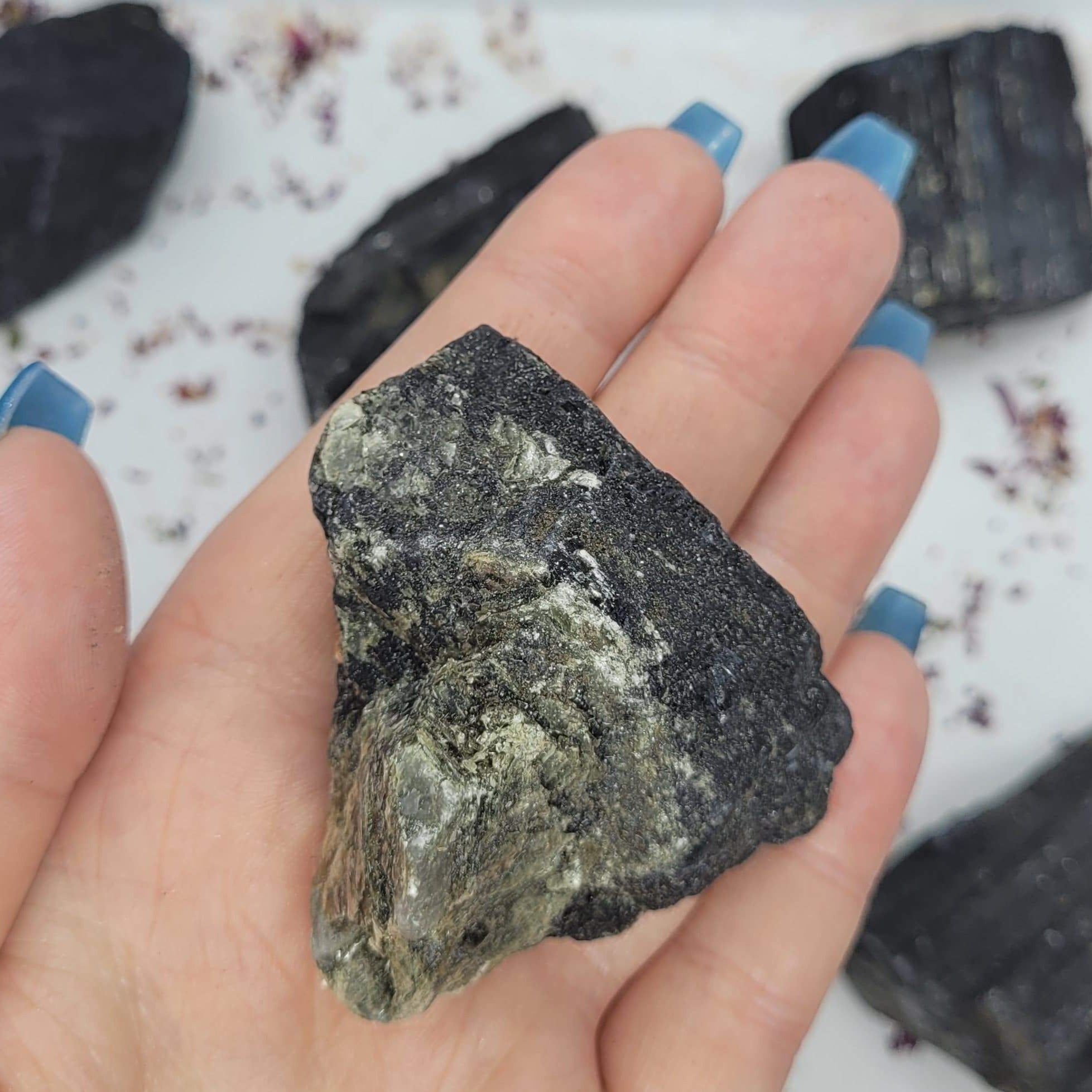 Raw chunks of Black Tourmaline showcasing their unique textures and deep black color, ideal for protection and grounding.