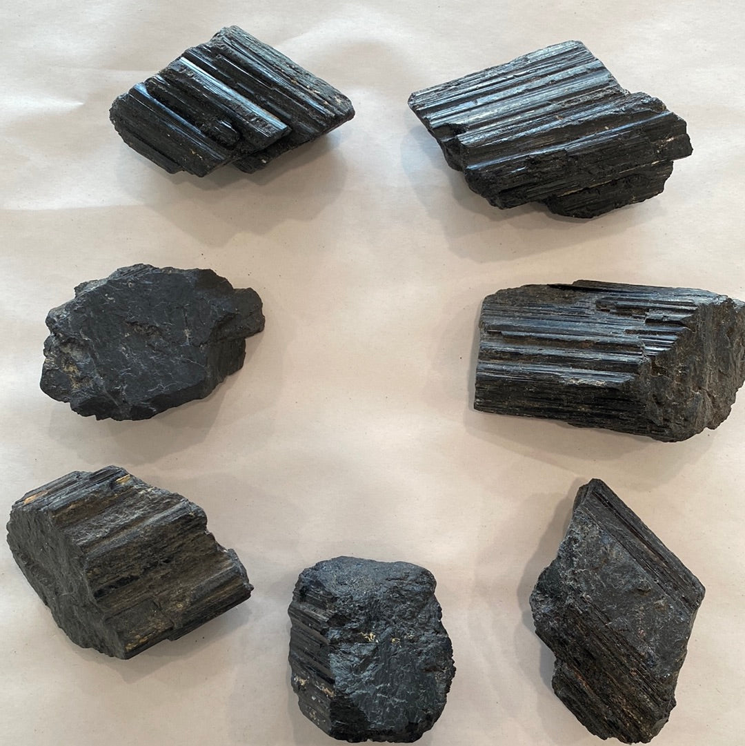 A collection of unique Black Tourmaline Rough Cut Small stones, showcasing their natural beauty with Mica and Quartz inclusions.