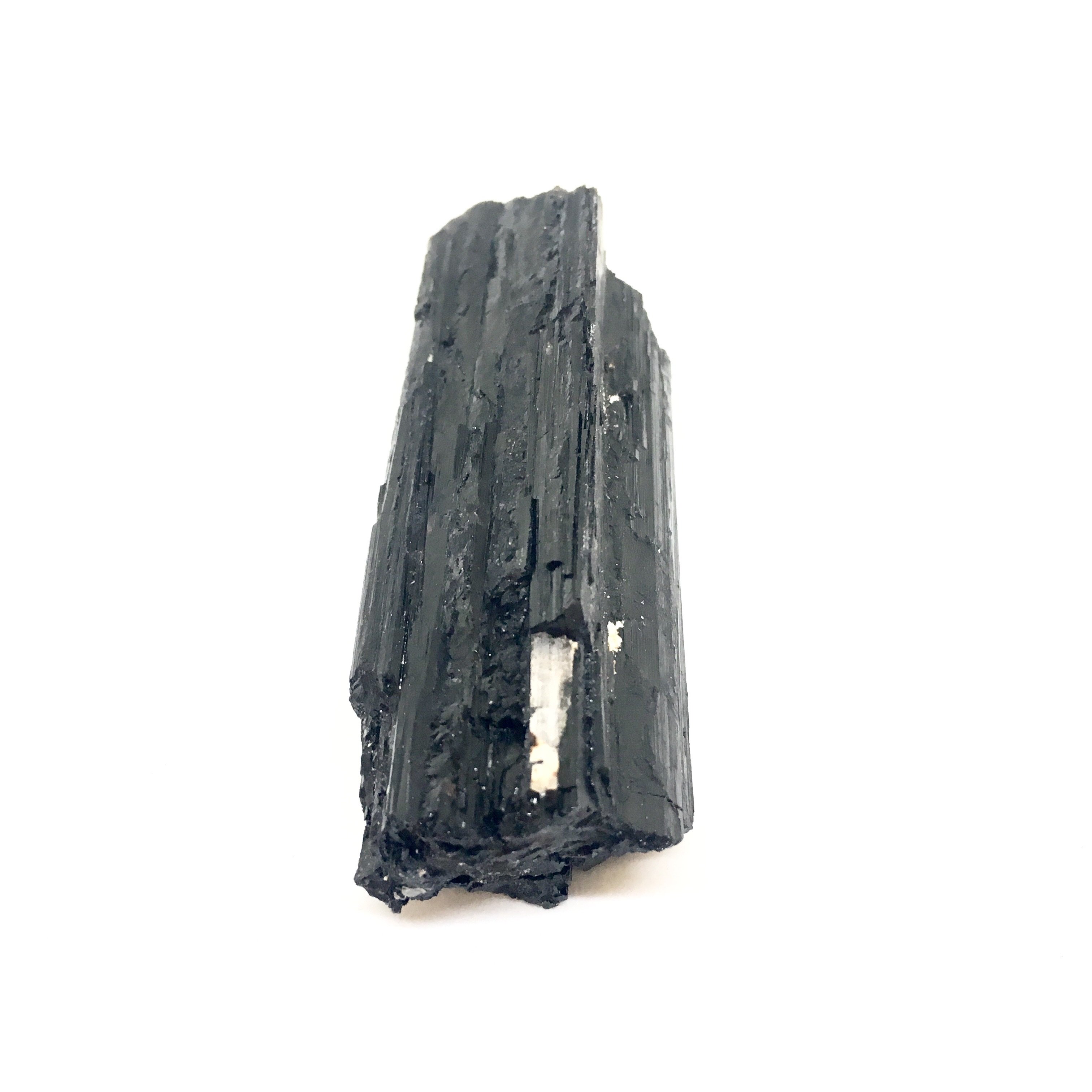 A close-up view of Black Tourmaline Sticks, showcasing their natural texture and dark color, ideal for psychic protection and grounding.