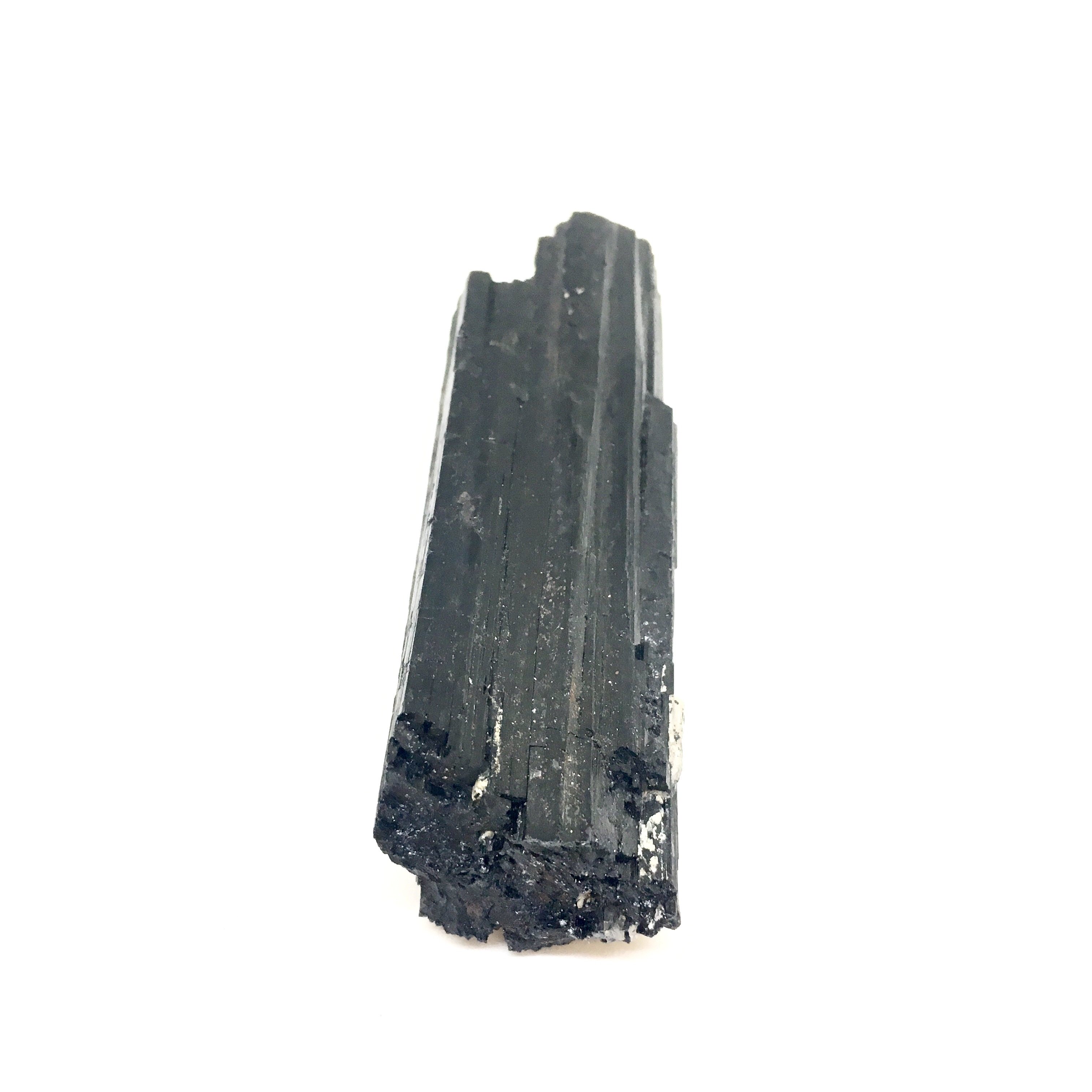 A close-up view of Black Tourmaline Sticks, showcasing their natural texture and dark color, ideal for psychic protection and grounding.