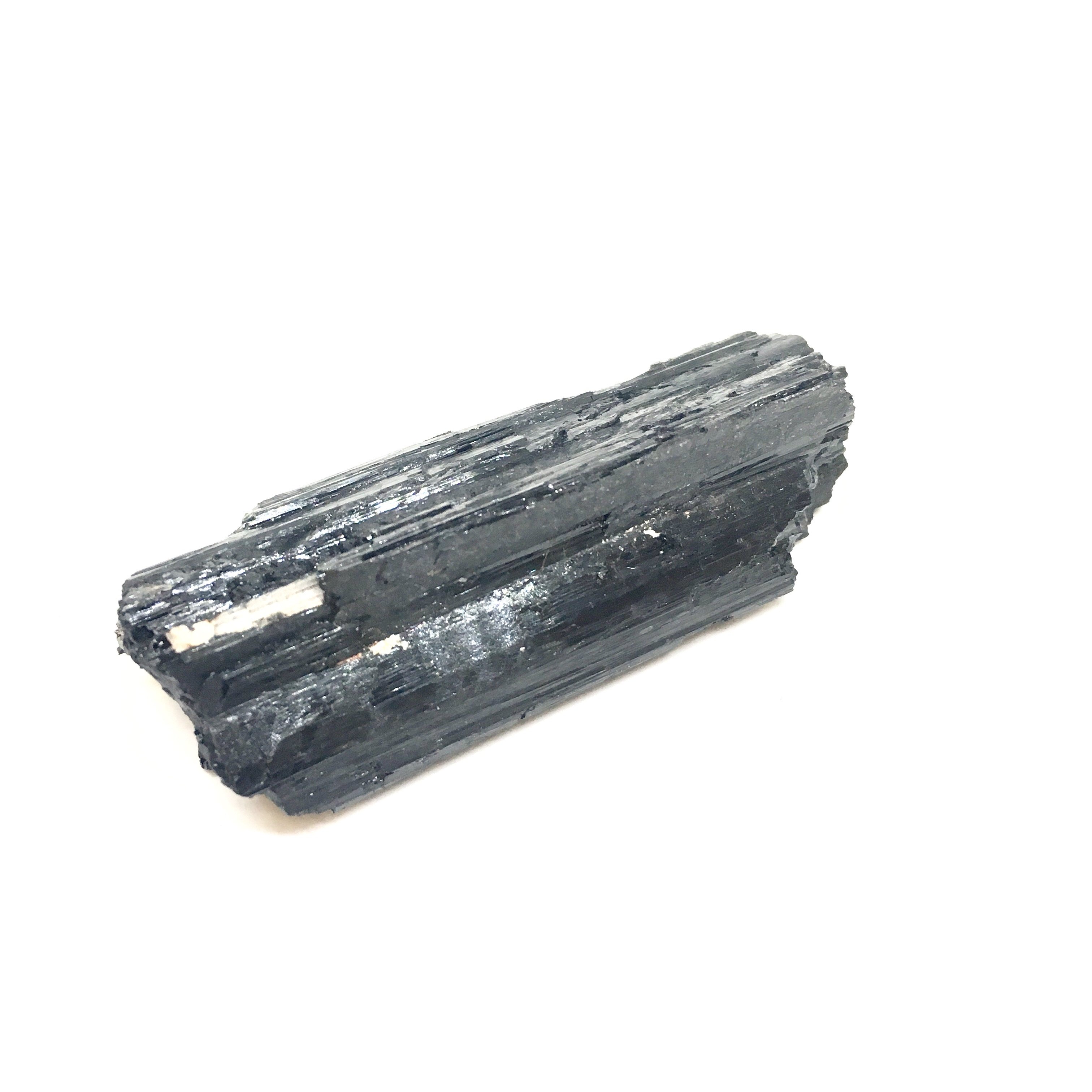 A close-up view of Black Tourmaline Sticks, showcasing their natural texture and dark color, ideal for psychic protection and grounding.