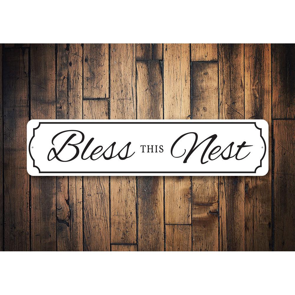 A beautifully crafted Bless This Nest Sign made of quality aluminum, featuring a charming design suitable for home decor.